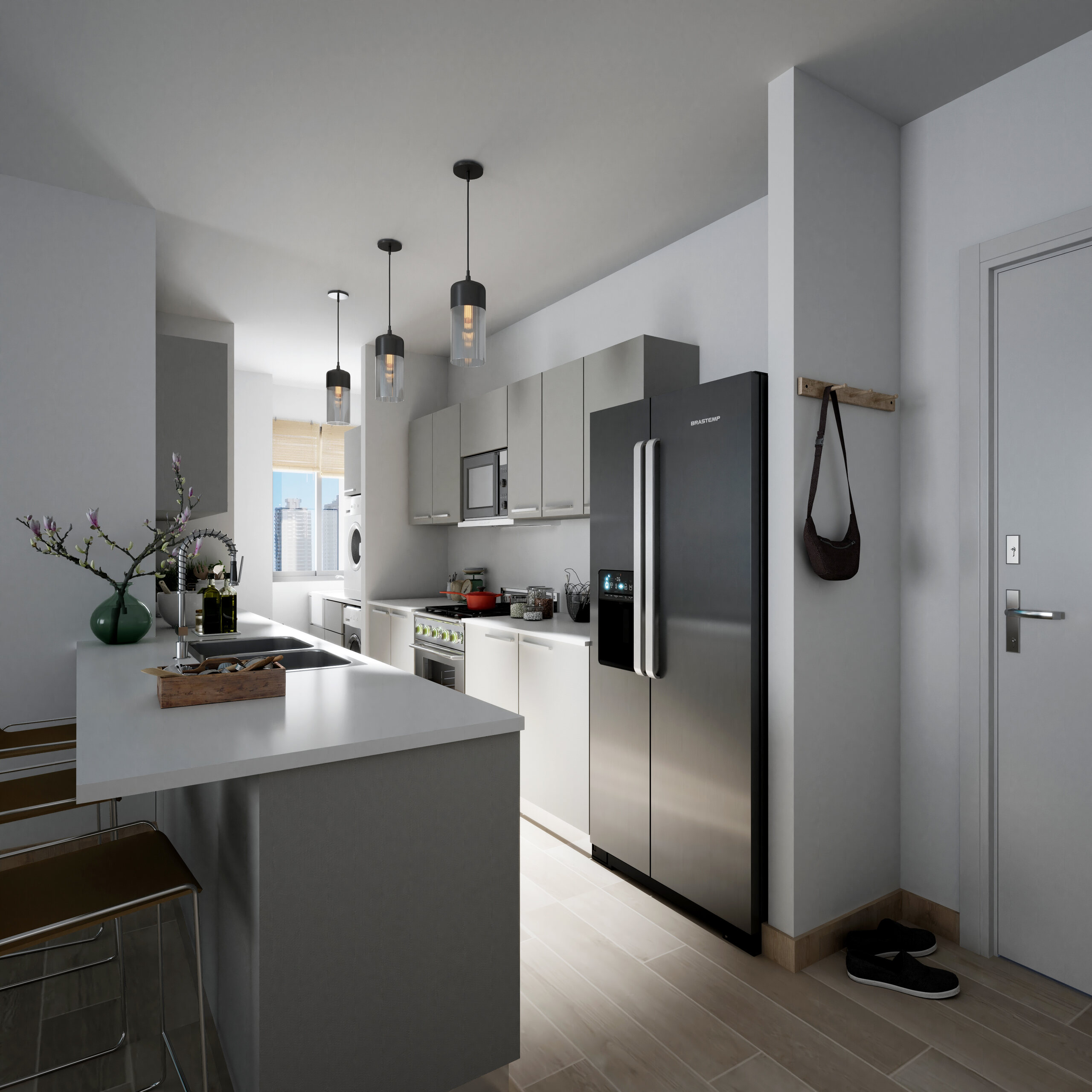 Cocina moderna con isla, gabinetes grises y refrigerador de acero inoxidable.